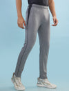 Hint track pant with side panel and piping and side pockets with zippers on both side with self fabric elasticated waistband with draw cord